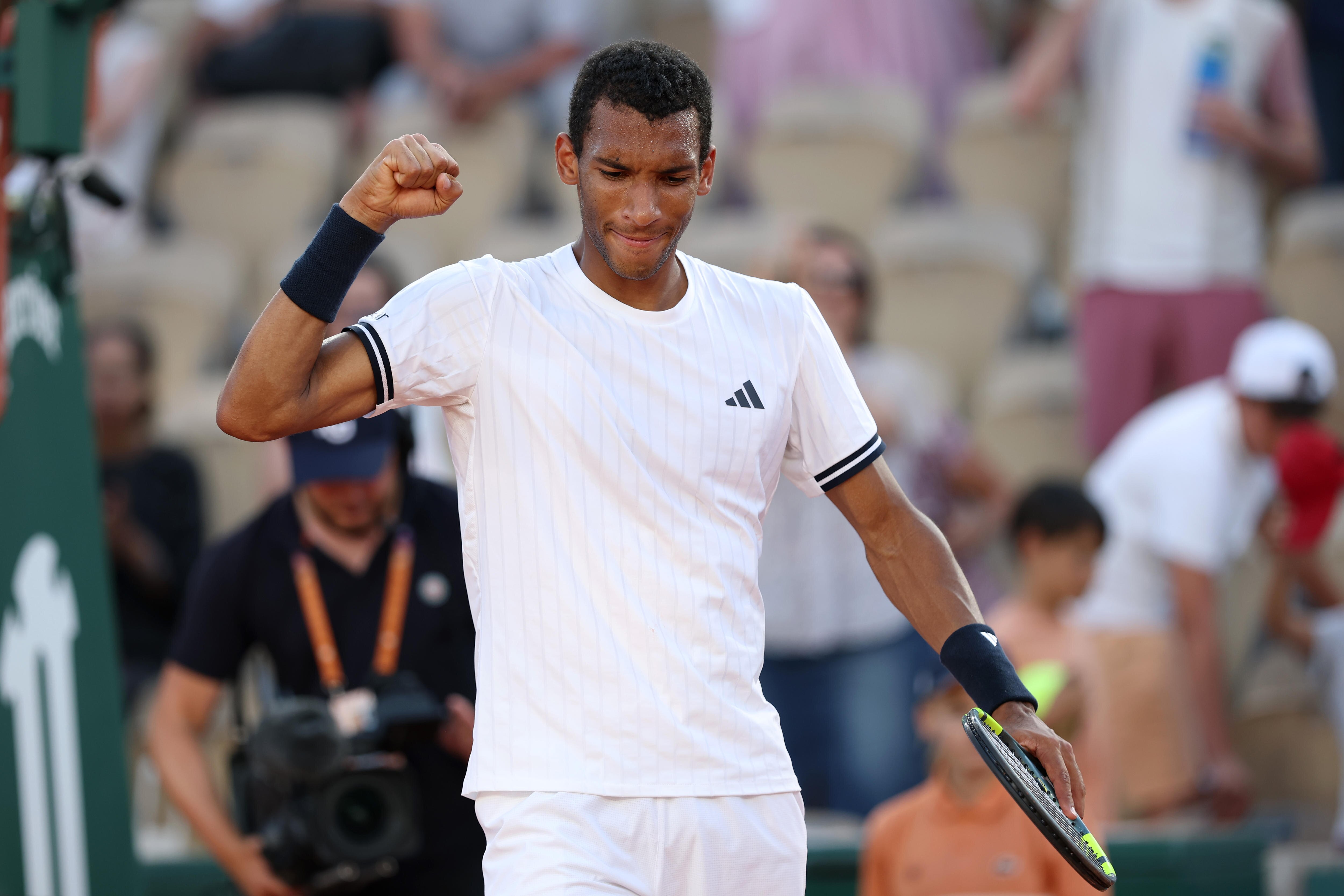 Felix Auger-Aliassime  pumps his fist after winning a match at the French Open.