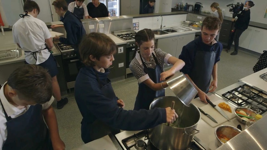 School students in a home economics kitchen