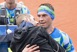 Kevin Sinfield carries Rob Burrow over the line at the Leeds Marathon.