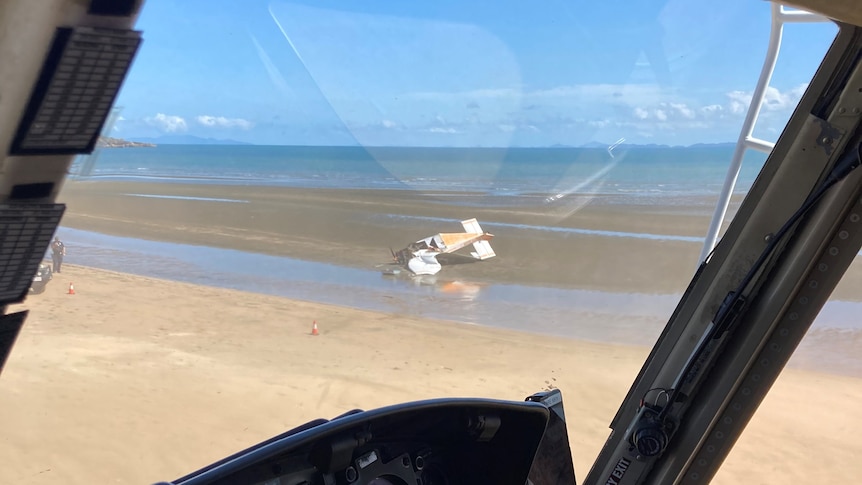 A small plane after a crash on a beach.