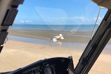 a small plane crashed on a sandy area