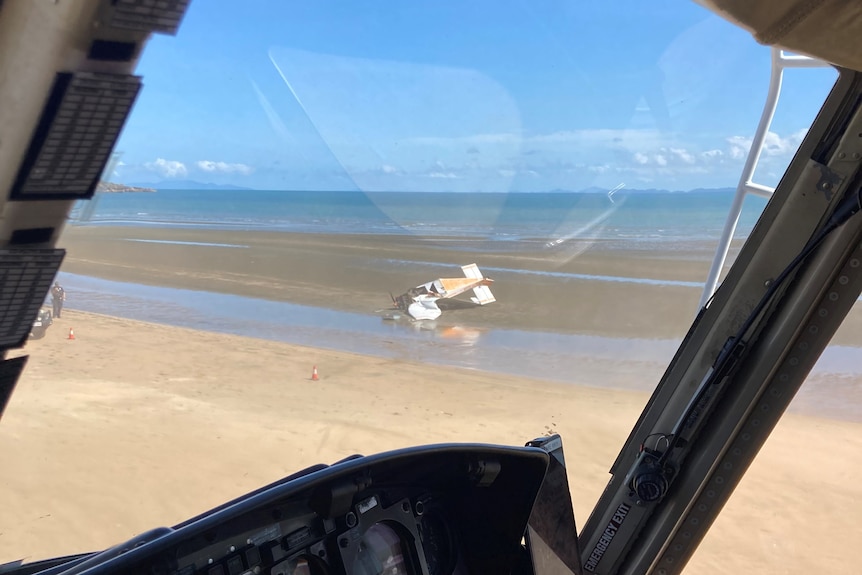 a small plane crashed on a sandy area