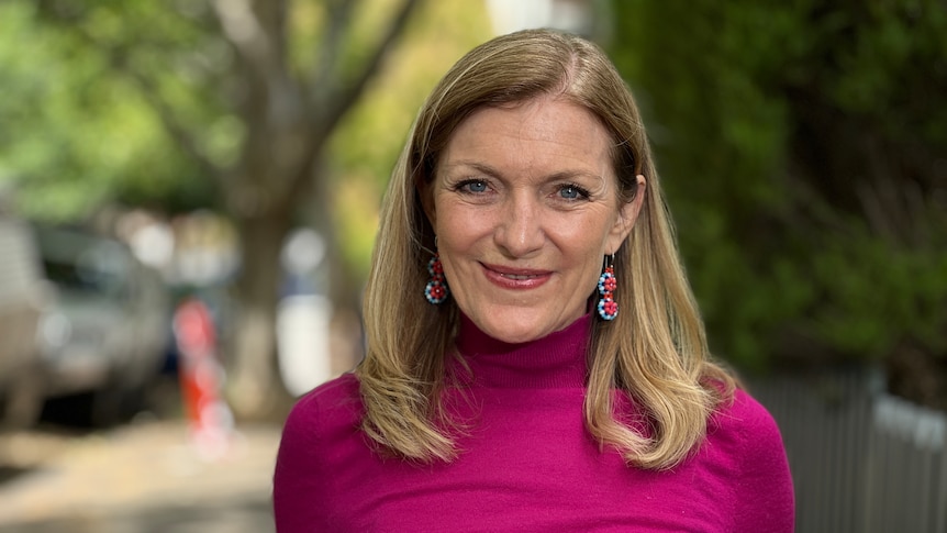 Fiona Patten wearing a magenta turtleneck.