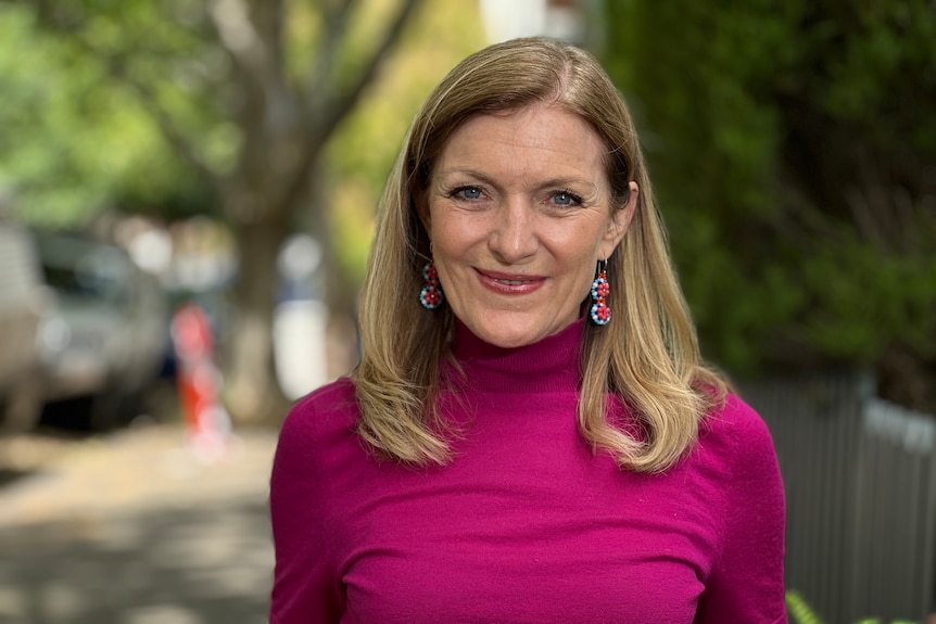 Fiona Patten wearing a magenta turtleneck.