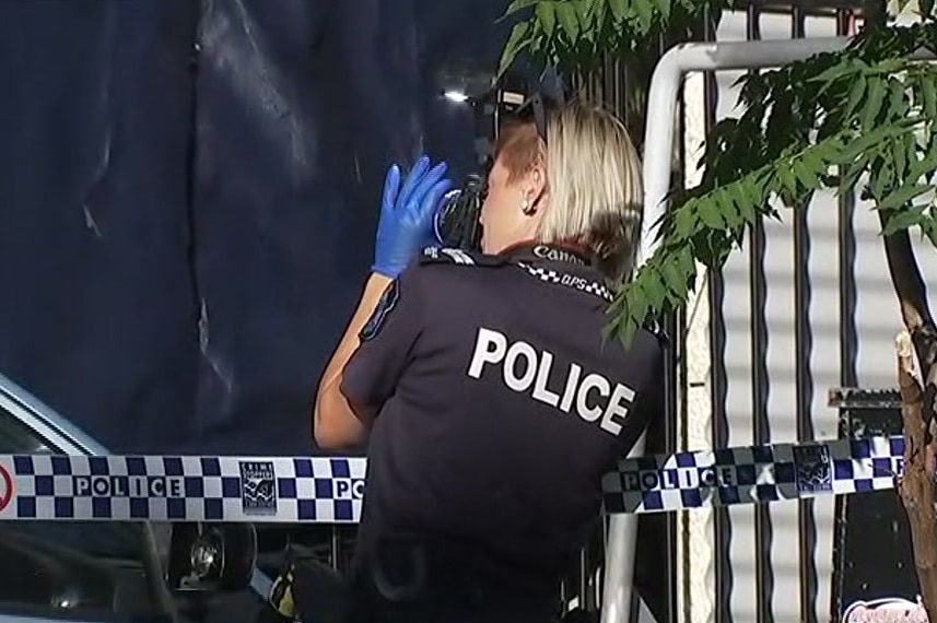 Forensic officer takes photos at the scene of a shooting at Carrara on the Gold Coast on Janurary 8, 2018.
