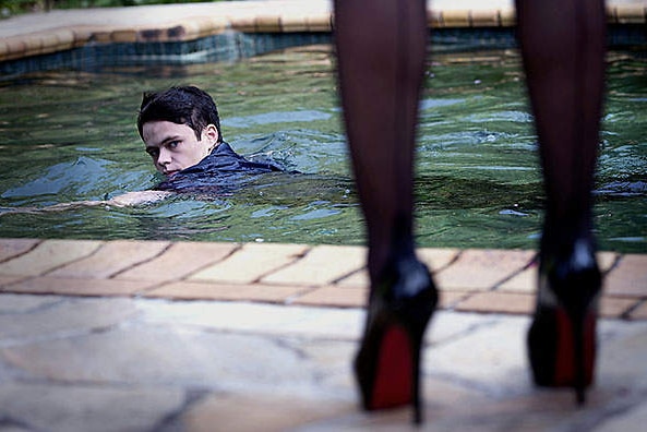 Leading actress Emmanuelle Béart plays a dominatrix, and is seated beside actor Harrison Gilbertson on a leather couch.