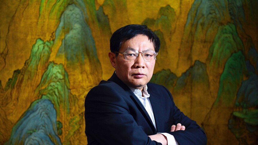 Chinese real estate mogul Ren Zhiqiang poses for photos in his office in Beijing.