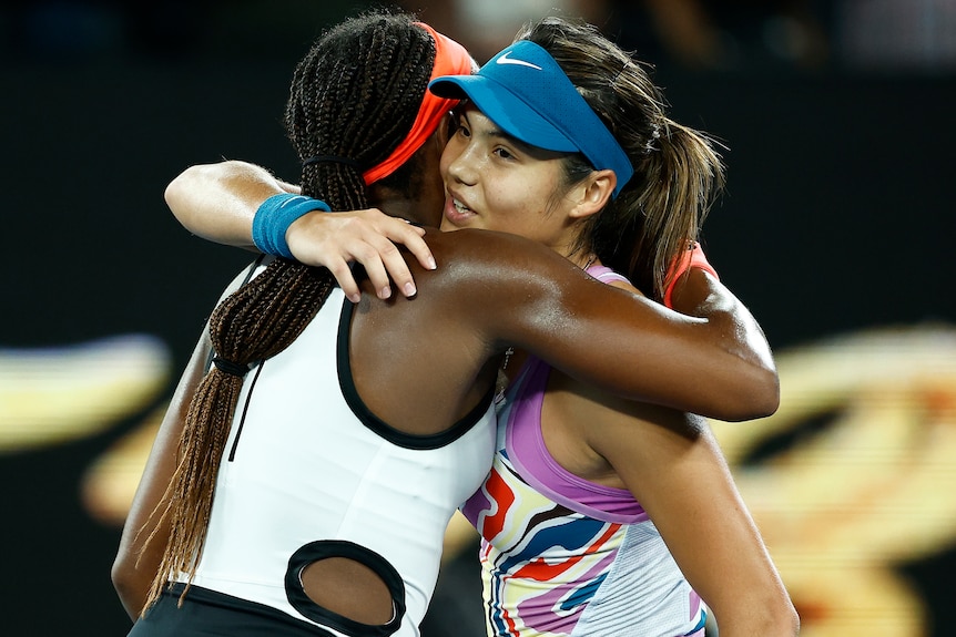 Coc Gauff and Emma Raducanu hug each other at Australian Open.