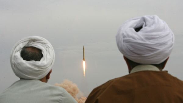 Iranian clergymen watch a Shahab-3 long-range ballistic missile fired in the desert outside the holy city of Qom (AFP)