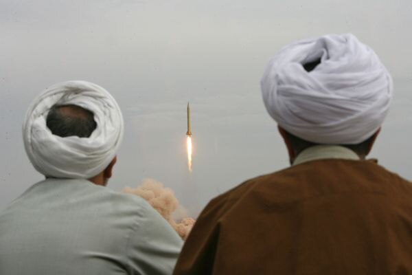 Iranian clergymen watch a Shahab-3 long-range ballistic missile fired in the desert outside the holy city of Qom (AFP)