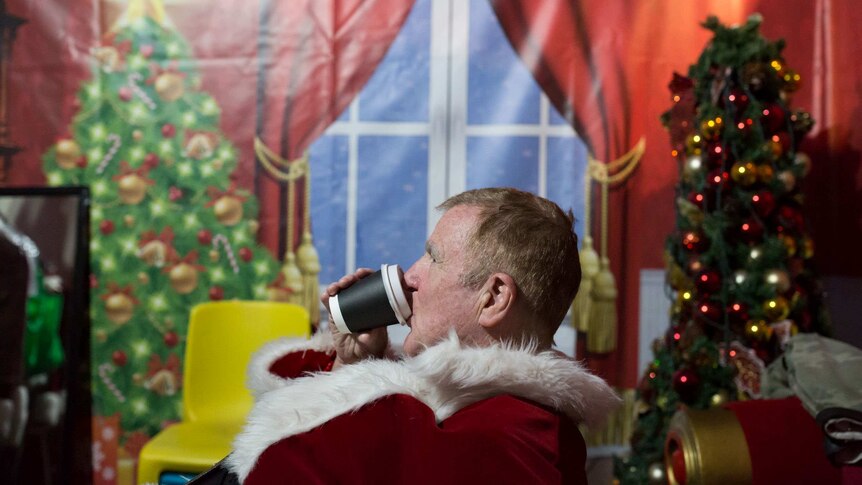 One of the Santas takes a coffee break.
