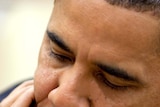 President Barack Obama looks downward