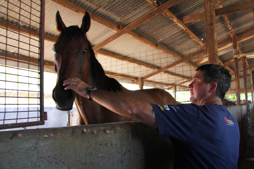 Todd Austin with one of the horses he trains