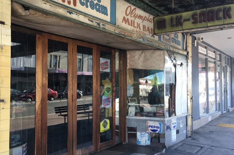 Photo of the front of the Olympia Milk Bar windows and signs.
