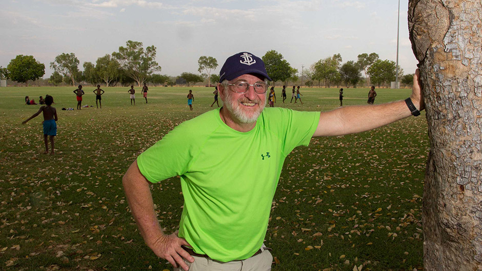 Geoff Davis stands in front of the Friday afternoon football games he organises for children in Fitzroy Crossing.