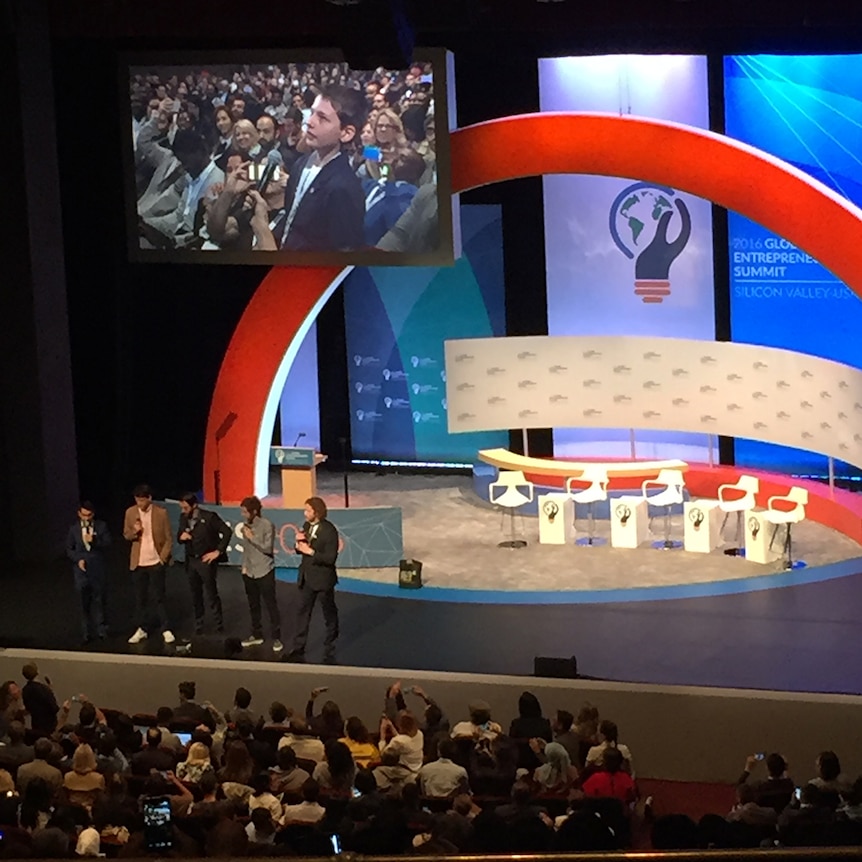 Hamish Finlayson appears on a screen above the stage at the global entrepreneurship summit 2016