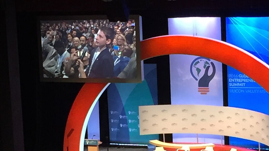 Hamish Finlayson appears on a screen above the stage at the global entrepreneurship summit 2016