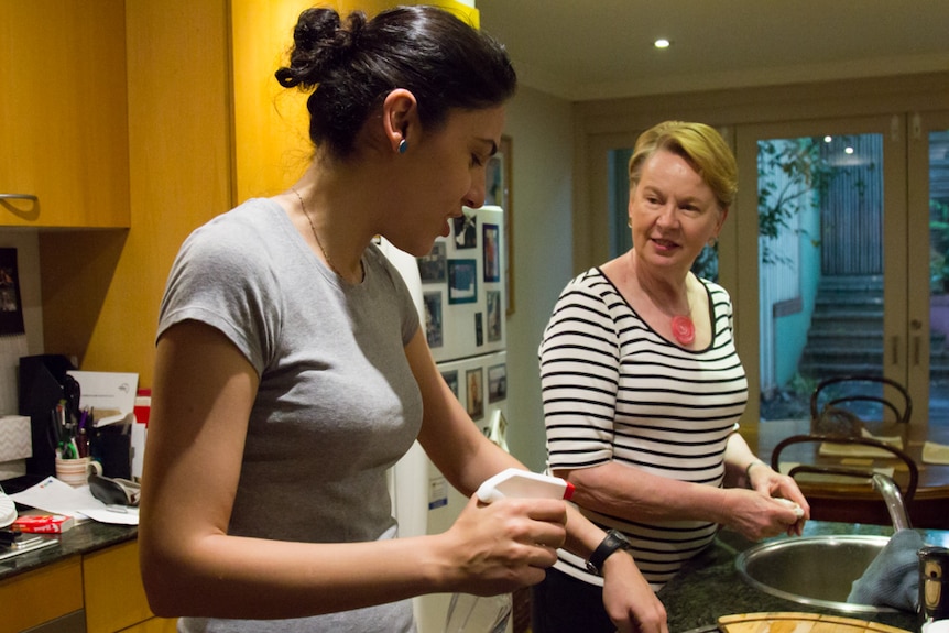 Barbara Squires and Niloufar Imanriad chat in the kitchen