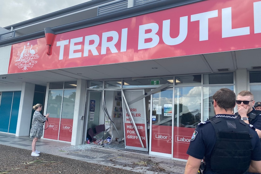 The damaged exterior of an electoral office with glass shattered.