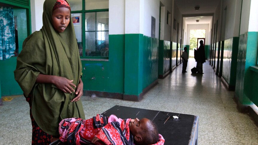 A Somali woman attends to her malnourished child in the paediatric ward at Banadir hospital in southern Mogadishu.