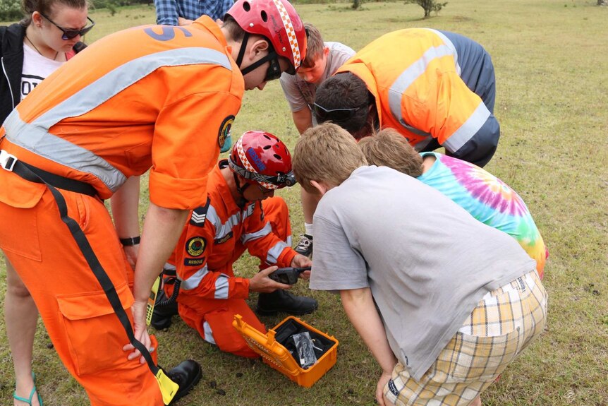 SES crews give some radios to campers stranded by floodwater in the Deua National Park