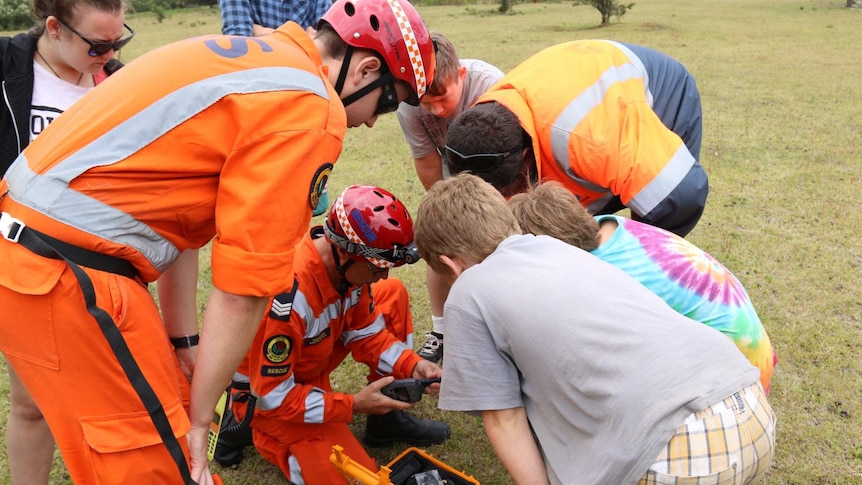 SES crews give some radios to campers stranded by floodwater in the Deua National Park