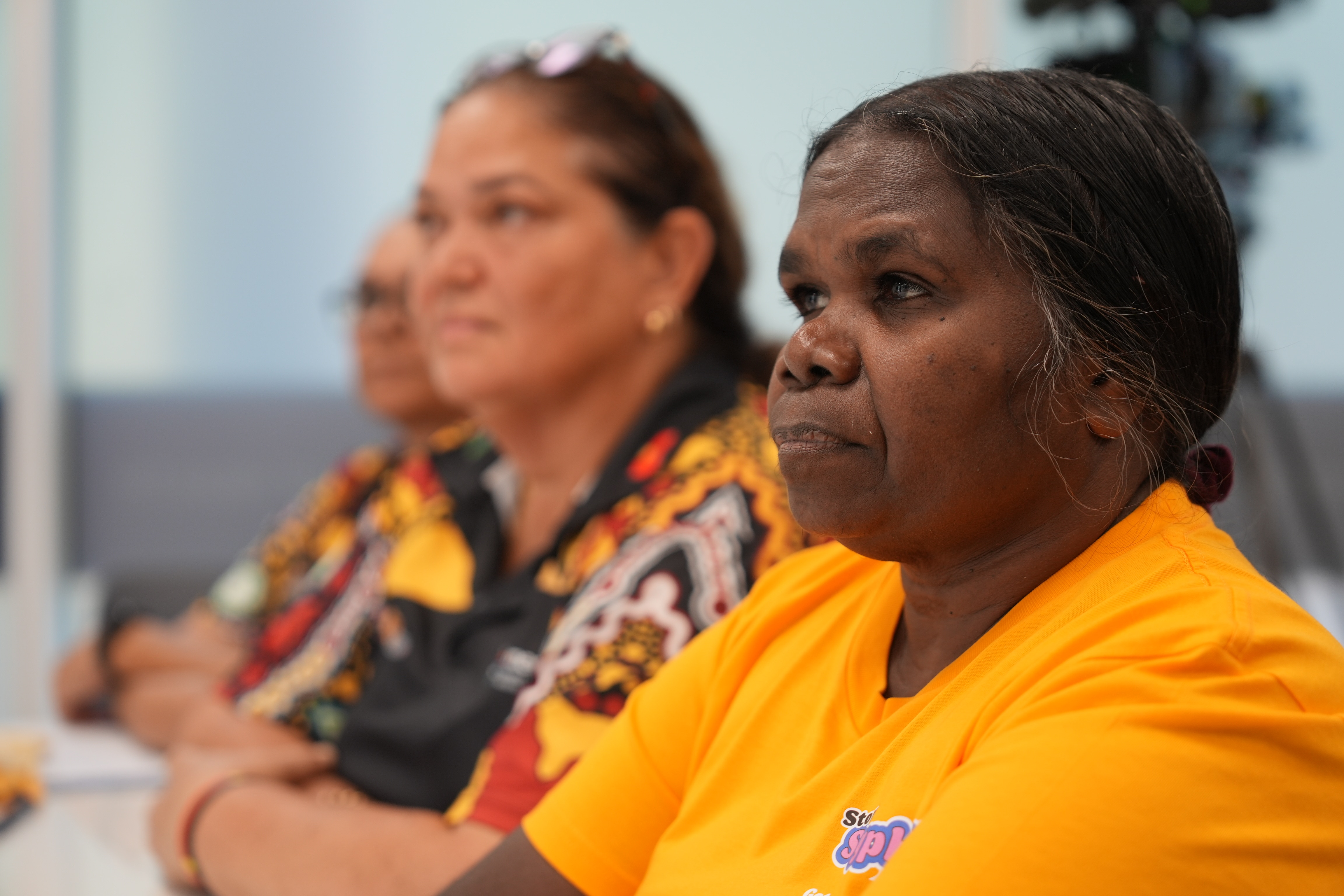 An Indigenous healthcare sitting at a desk, undertaking a training session.