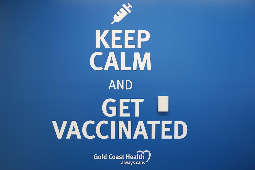 Blue sign 'Keep calm and get vaccinated' at Gold Coast University Hospital.