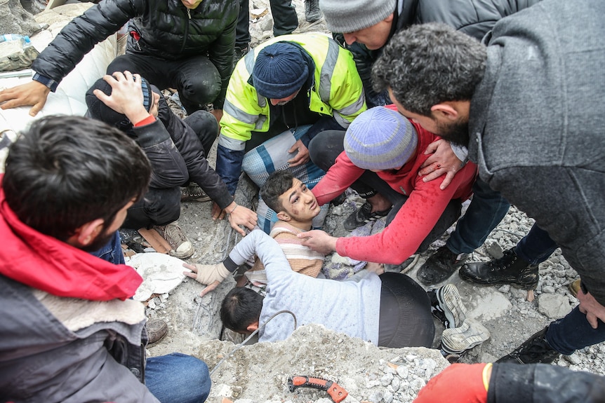 A man is pulled from rubble in Turkey alive.