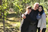 Stephen Taylor hugs his daughters, Ariel (l) and Morgan (r), in his backyard