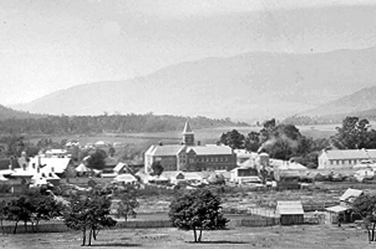 An old black and white photo of colonial era buildings in Tasmania.