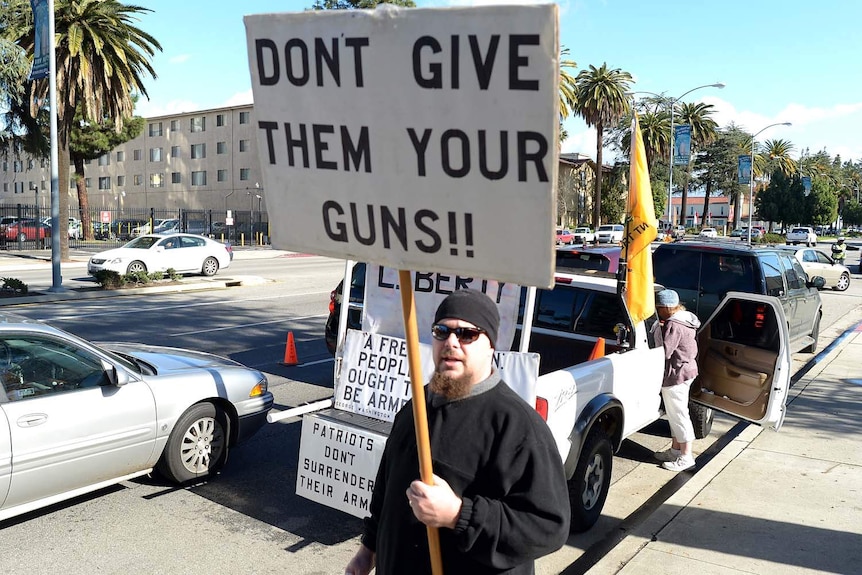 A pro-gun activist carries a placard
