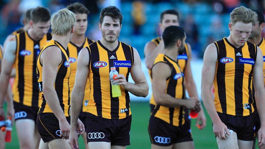 Isaac Smith (3L) and other Hawthorn team members leave York Park after losing to St Kilda.