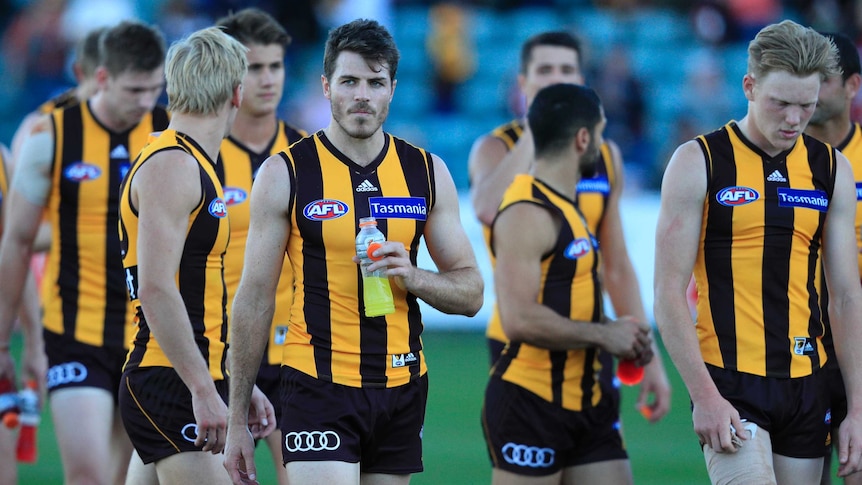 A dejected Isaac Smith and team-mates leave the field after Hawthorn's loss to St Kilda