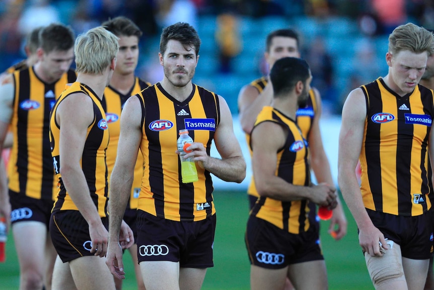 A dejected Isaac Smith and team-mates leave the field after Hawthorn's loss to St Kilda