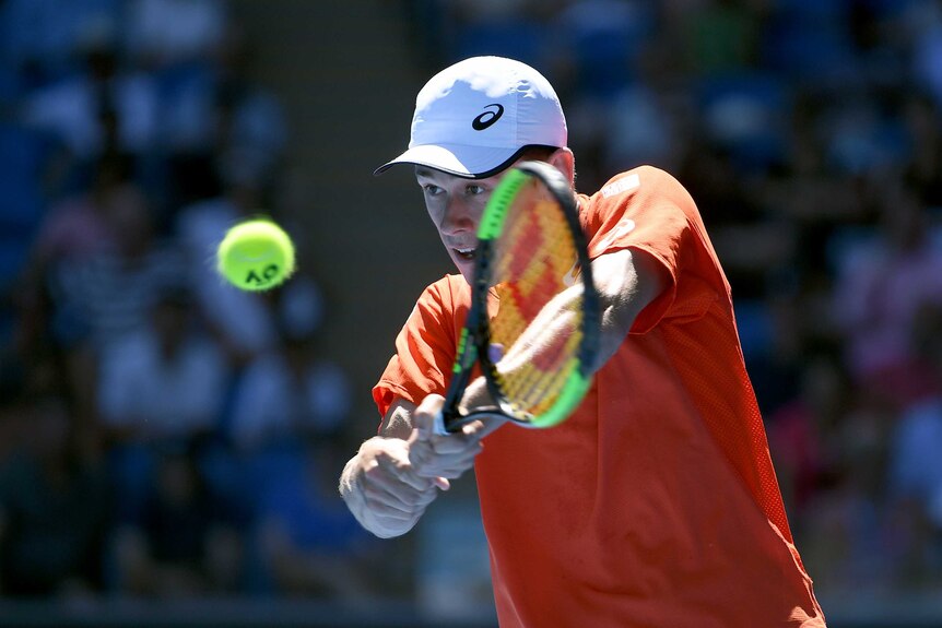 Alex De Minaur hits a double-handed backhand during his Australian Open match against Pedro Sousa