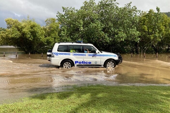 A police car moving through floodwaters in Tumbulgum.