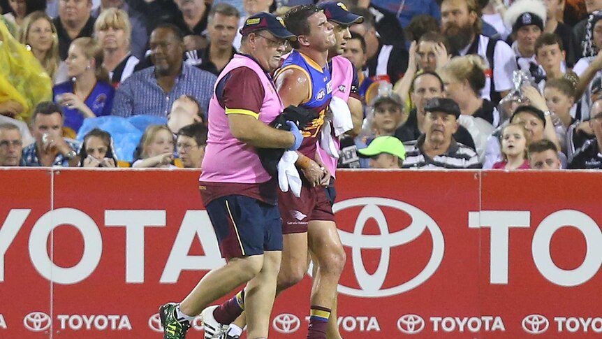 Brisbane's Tom Rockliff is taken from the field injured in round one, 2015 against Collingwood.
