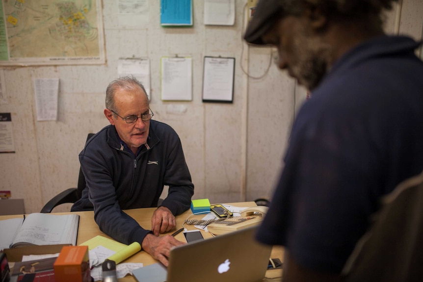 A Warburton Centrelink officer helps local man Dereck Harris with a Centrelink claim.