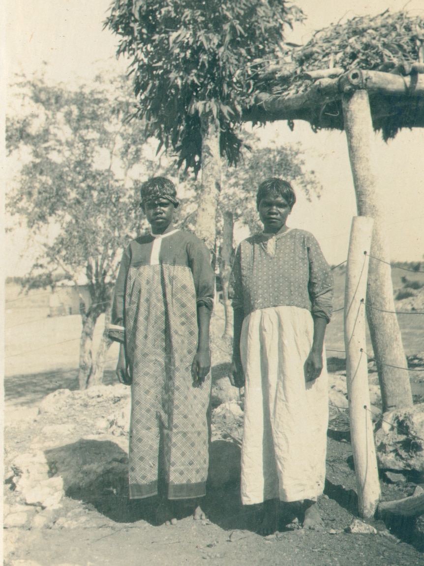 June Oscar's aunty (left) and grandma (right) stand in front of a wire fence on a property