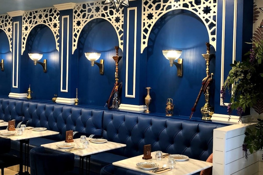 an empty restaurant with shisha pipes on the walls