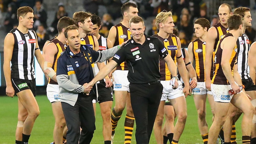 Mark of respect ... Alastair Clarkson (L) and Nathan Buckley shake hands after both the Hawks and Magpies paid respect to Phil Walsh