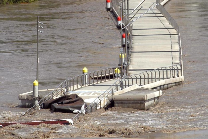 The floating walkway along the Brisbane River between the CBD and New Farm lies in ruins on January 12, 2011 after the flood.