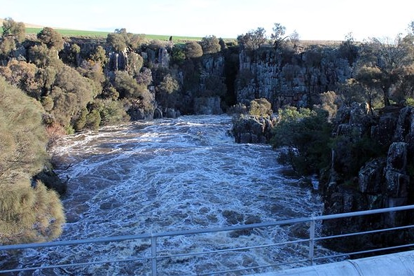 river flooding with bridge in the foreground