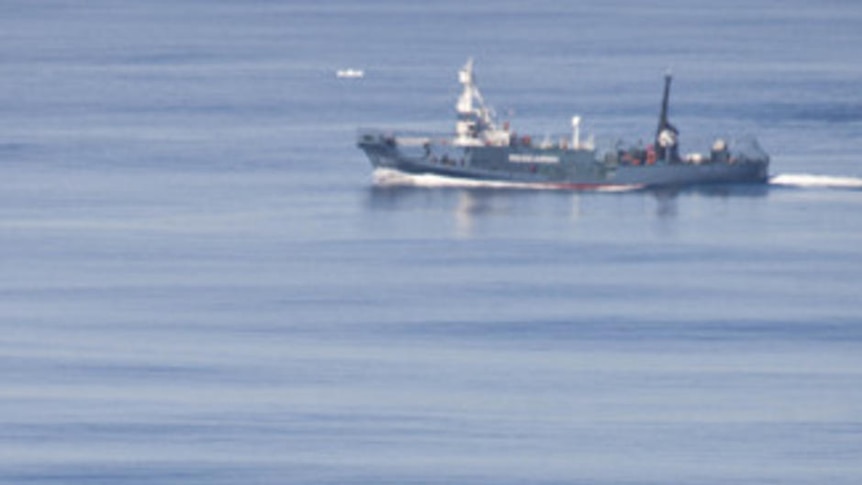 The Yushin Maru 3 sprays a water canon at the Sea Shepherd's Zodiac boat
