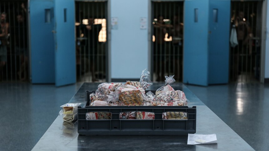 Sandwiches on table with prison cells in background