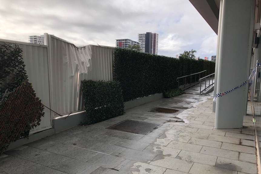 Buckled fence at apartment block