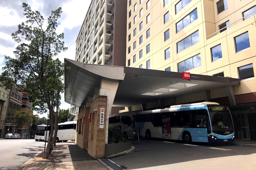 Buses line up at the entrance to the Ibis Hotel.