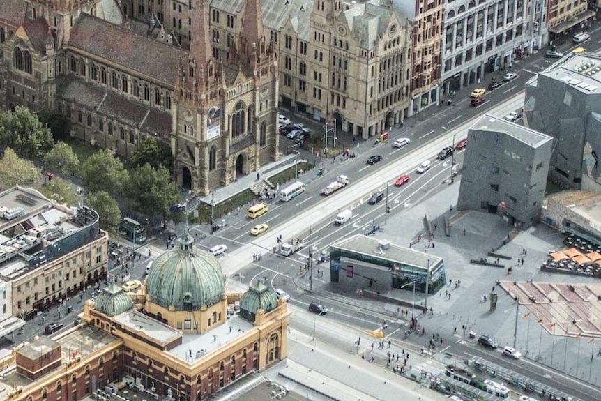 Aerial shot showing Melbourne's Flinders St Station, Federation Square and St Pauls Cathedral.