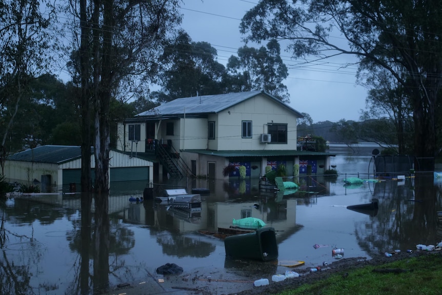 A home near Windsor, New South Wales, is completely flooded up to the front door handles. 